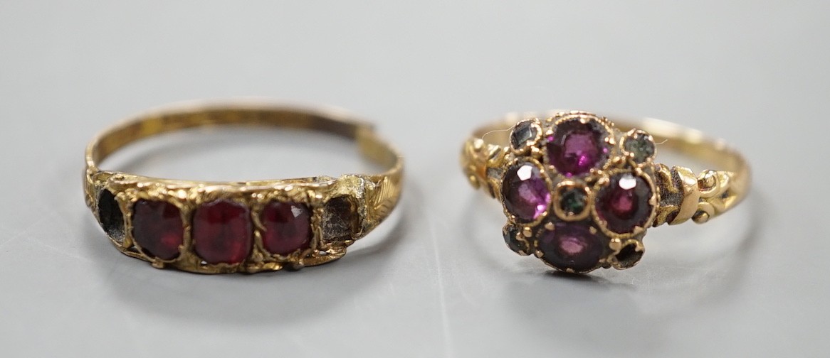 A 19th century 15ct gold, garnet and green stone cluster set ring (stone missing), size N/O, gross 1.6 grams and a similar 12ct gold and gem set ring (a.f.), gross 1.4 grams.